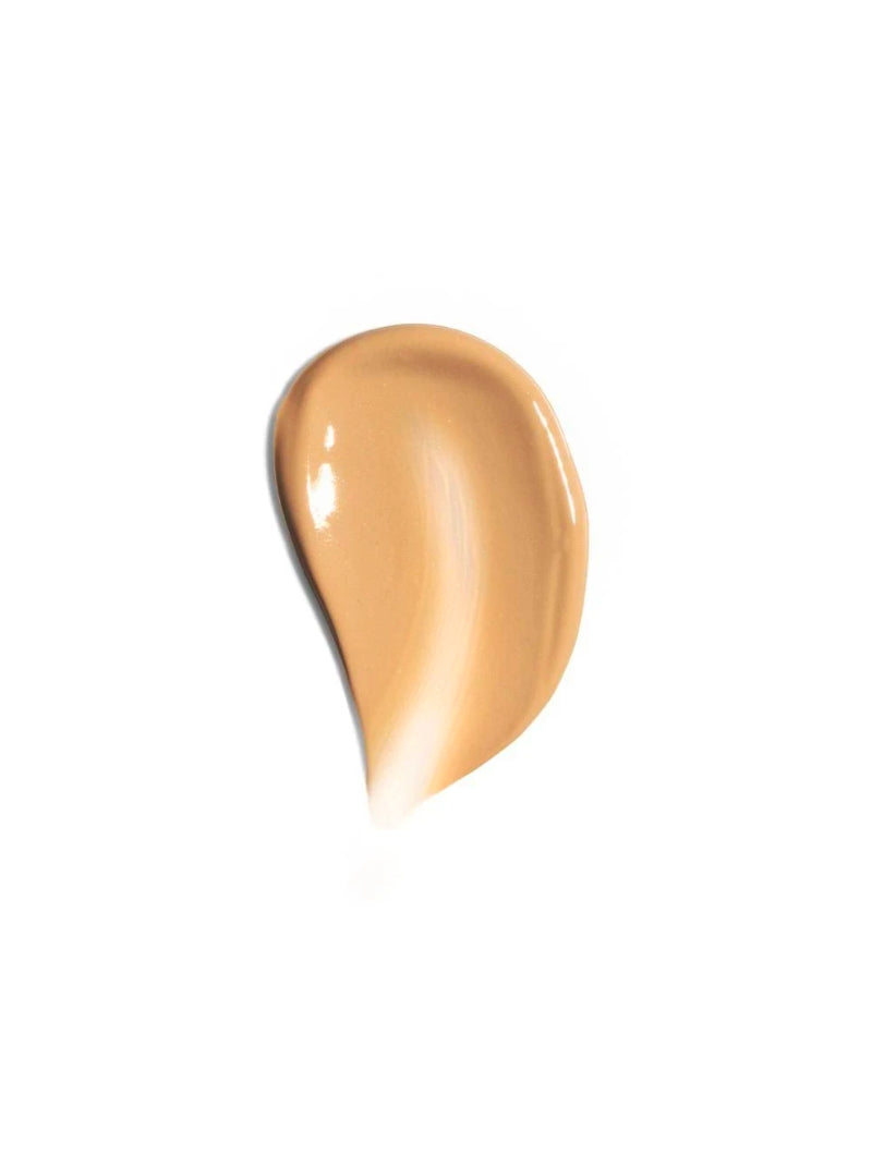 smear of tinted sunscreen on white background