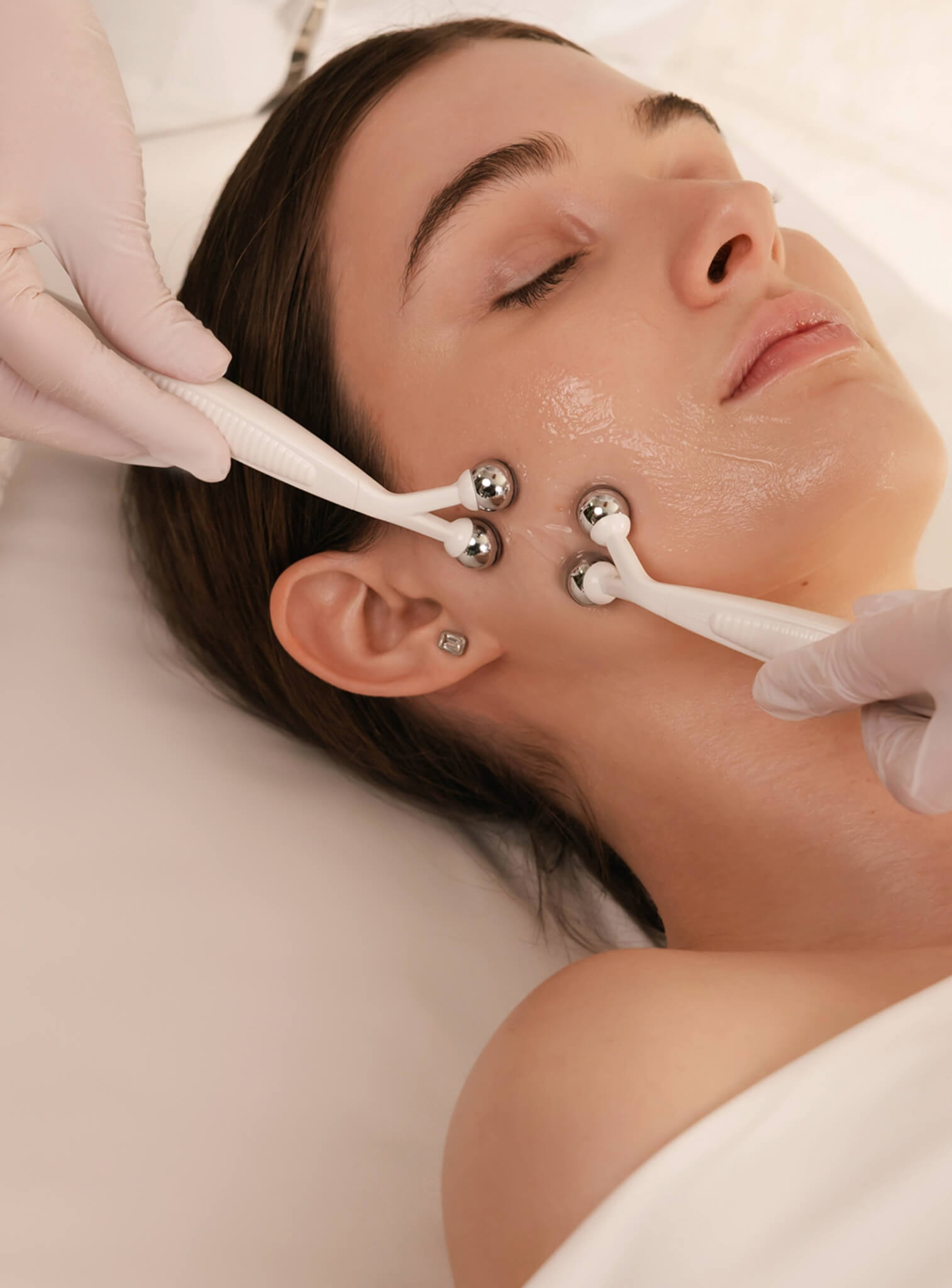 Woman receiving a facial treatment with electronic devices on her face